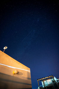 Low angle view of building against clear sky at night