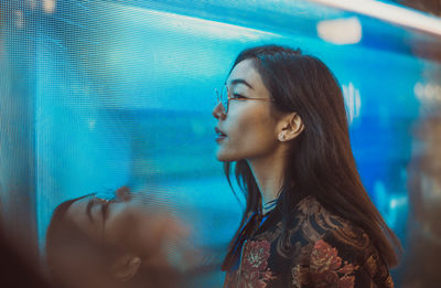 Portrait of young woman looking at swimming pool