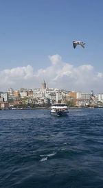 Boats in river with buildings in background