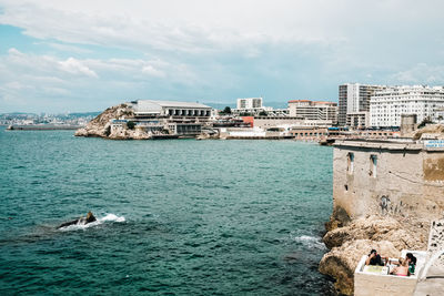 View of sea and buildings in city