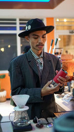 Young man in passionate with coffee . grinder on hand and ready for serving some coffee.