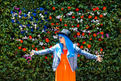 Woman standing by flowers