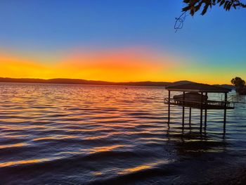 Scenic view of sea against clear sky during sunset