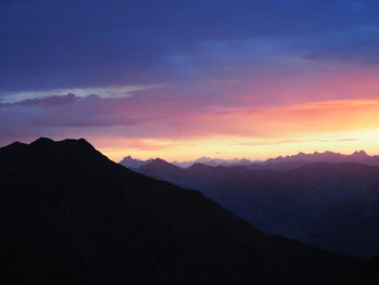 Scenic view of silhouette mountains against sky during sunset