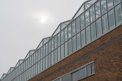 Low angle view of modern building against clear sky