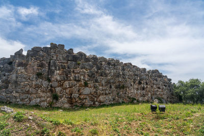 Old ruin on field against sky