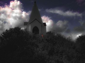 Low angle view of church against cloudy sky