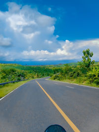 Road passing through landscape against sky