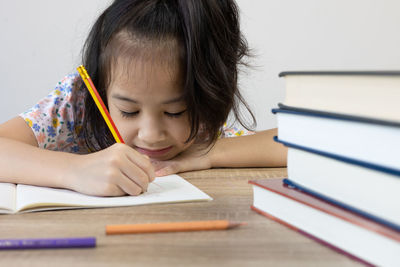 Close-up of girl drawing on book