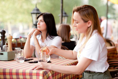 Young woman sitting at restaurant table