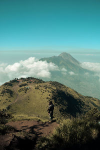 A climber looking merapi volcano from merbabu mountain, indonesia