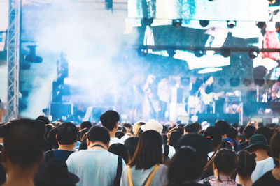 Rear view of people enjoying at music concert