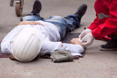 Paramedic performing cpr on person women on street