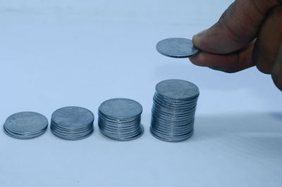 Close-up of hand holding coins