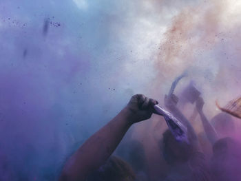 People throwing powder paint during holi