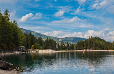 Scenic view of lake by trees against sky