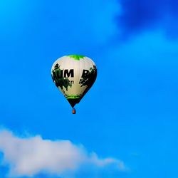 Low angle view of hot air balloon against blue sky