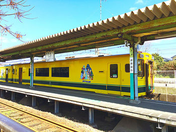 Train at railroad station against sky