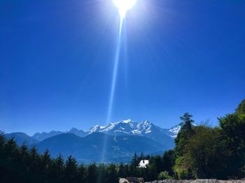 Scenic view of mountains against clear blue sky