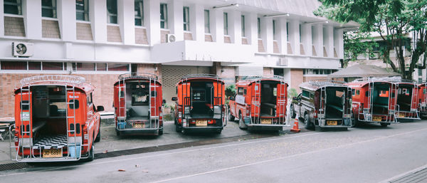 Traffic on road by buildings in city