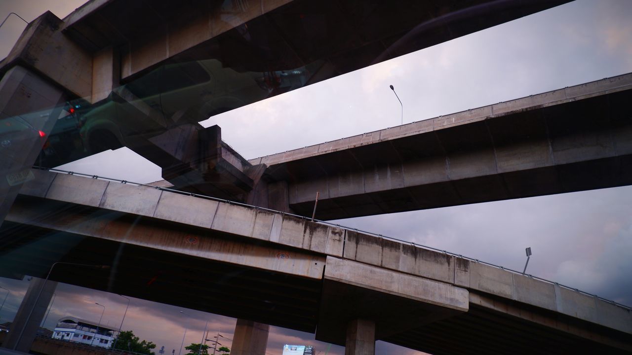 architecture, overpass, built structure, public transport, bridge, transportation, transport, city, urban area, low angle view, building exterior, no people, sky, business finance and industry, nature, outdoors