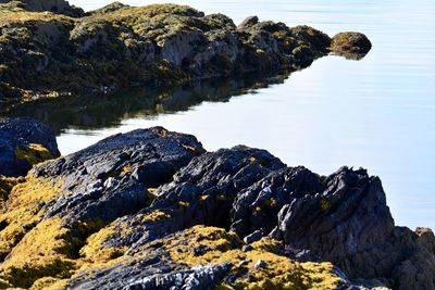 Rock formations by sea against sky