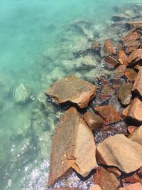 High angle view of rocks in sea