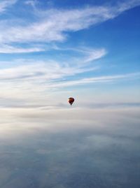 Hot air balloon flying against sky