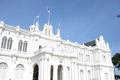 Low angle view of historic building against clear blue sky