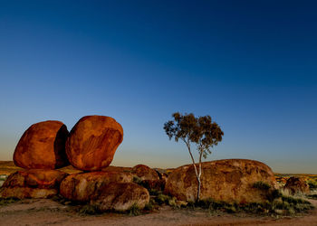 Rock formation in desert against clear blue sky