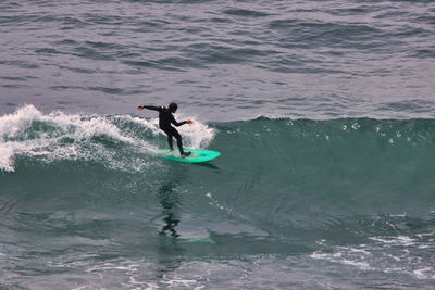 Full length of man surfing in sea