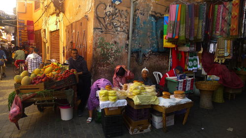 Vendors selling food items on old town street