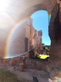 Scenic view of rainbow over rock formation