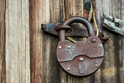 Close-up of padlock on metal door