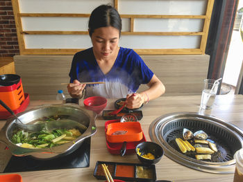 Woman eating a variety of foods