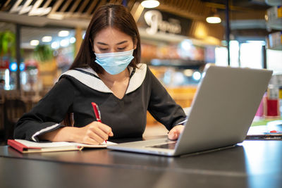 Woman using laptop on table