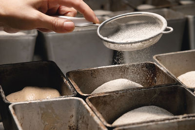 Cropped hand of woman preparing food