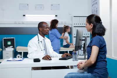 Doctor examining patient in laboratory