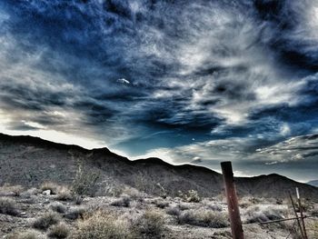 Scenic view of mountains against cloudy sky