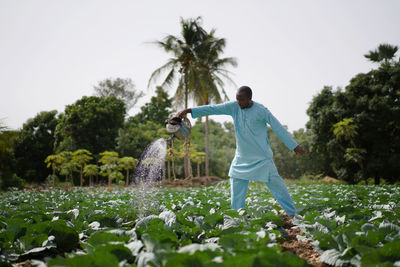 Full length of man standing by plants