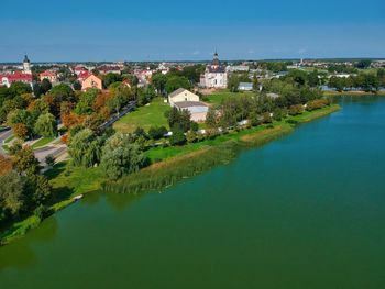 Panoramic view of buildings and trees against blue sky