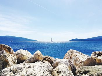 Scenic view of calm sea against blue sky