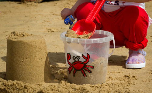 Close-up of baby playing at  beach