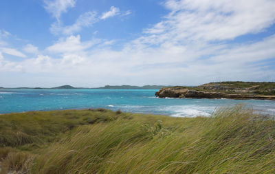 Scenic view of sea against cloudy sky