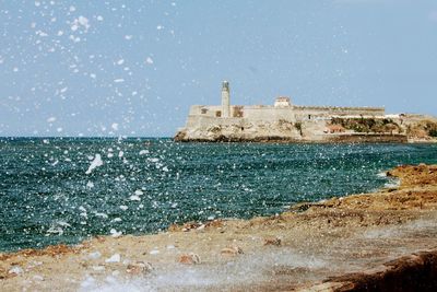 Built structure on beach against clear sky