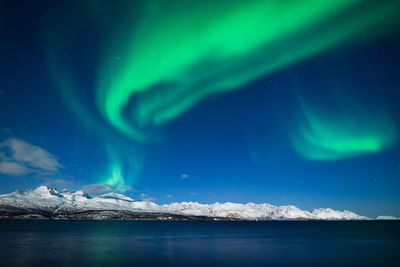 Scenic view of lake against sky at night