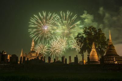 Firework display in city at night