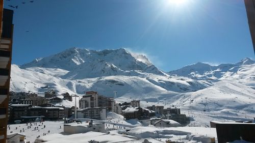 Scenic view of snow covered mountains against sky