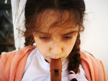 Close-up of girl playing flute