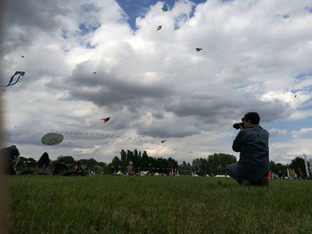 Full length of man flying kite against sky